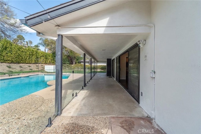 view of swimming pool with a patio area, a fenced in pool, and fence