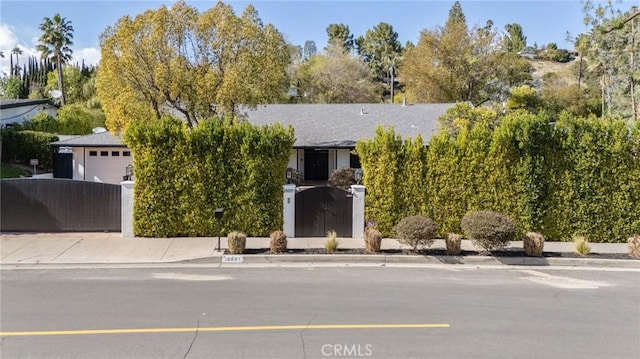 obstructed view of property featuring an attached garage