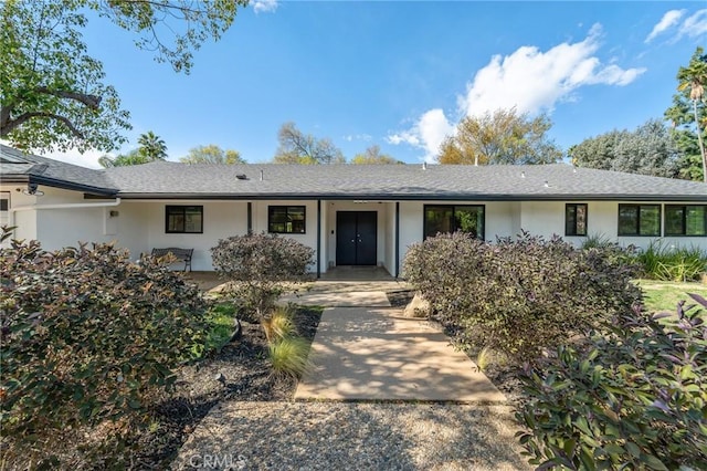 ranch-style house featuring stucco siding