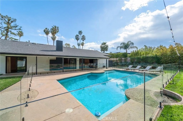 view of swimming pool with a fenced in pool, a patio area, and fence