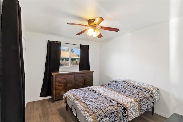 bedroom featuring a ceiling fan, wood finished floors, and baseboards