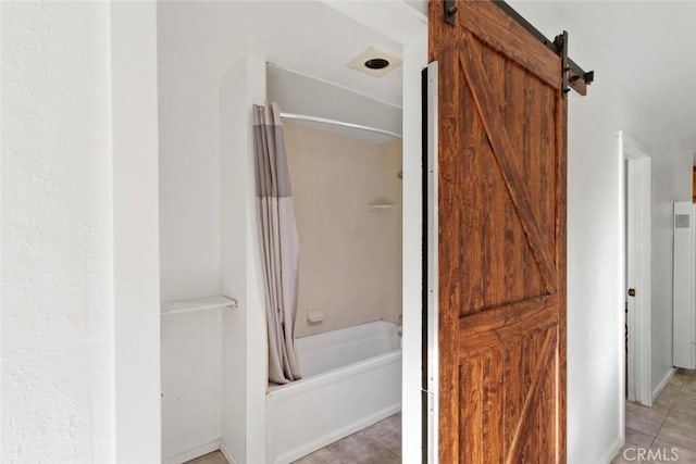 bathroom featuring shower / bath combination with curtain and tile patterned floors