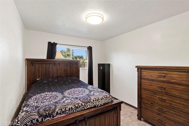 bedroom featuring baseboards and a textured ceiling