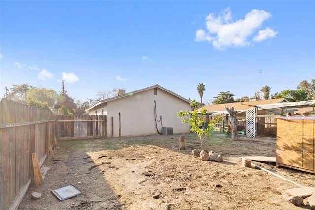 view of yard featuring cooling unit and fence