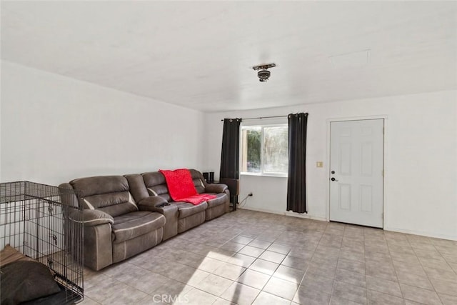 living room featuring tile patterned floors and baseboards