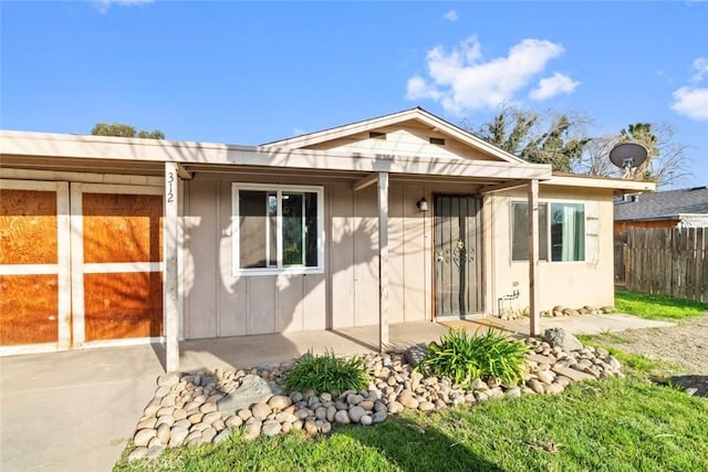 view of front of property with board and batten siding and fence