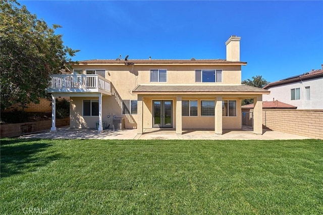 back of property featuring a patio, cooling unit, french doors, and a lawn