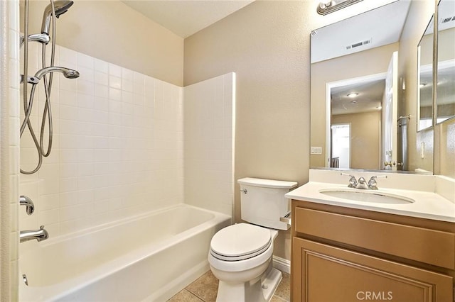 bathroom featuring tile patterned flooring, visible vents, washtub / shower combination, toilet, and vanity