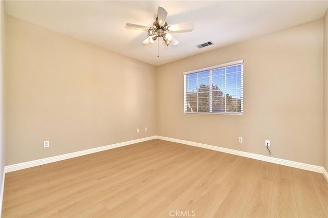 unfurnished room with visible vents, baseboards, light wood-style floors, and a ceiling fan