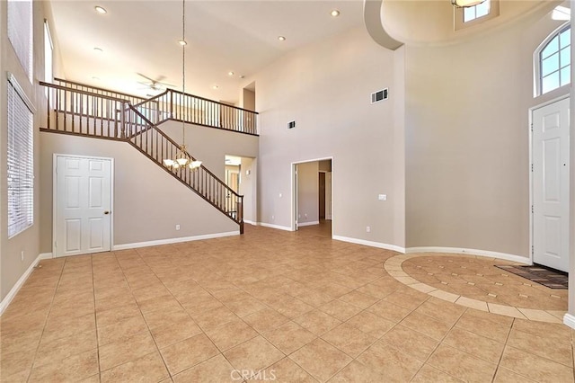 entryway featuring stairs, light tile patterned floors, baseboards, and visible vents