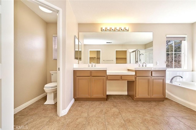 bathroom featuring a shower stall, toilet, a garden tub, and double vanity