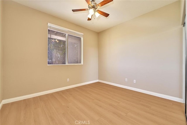 unfurnished room with ceiling fan, baseboards, and light wood-style flooring