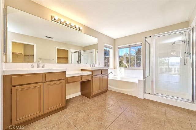 full bathroom featuring visible vents, double vanity, a sink, a shower stall, and a bath