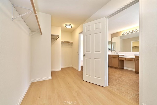 spacious closet with light wood-type flooring