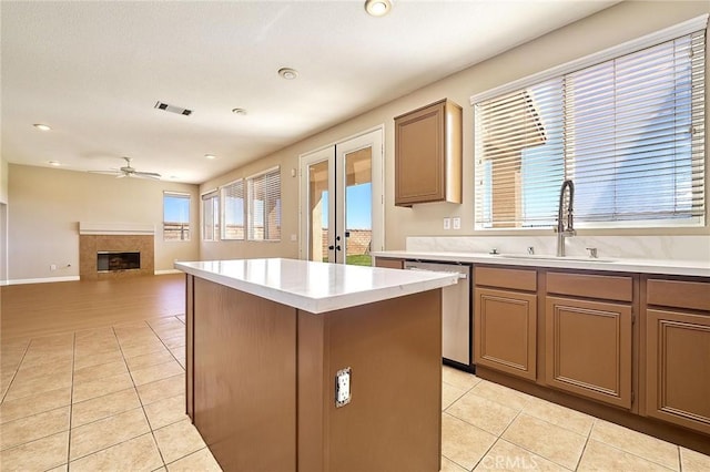 kitchen featuring ceiling fan, visible vents, stainless steel dishwasher, and light tile patterned flooring