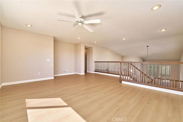 empty room featuring a ceiling fan, wood finished floors, recessed lighting, baseboards, and vaulted ceiling