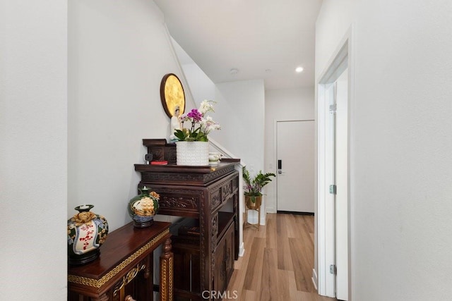 corridor with light wood finished floors and recessed lighting