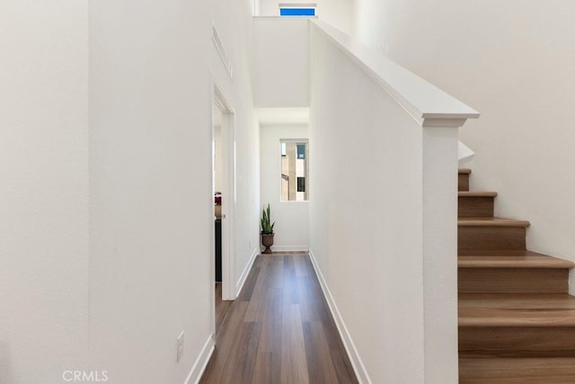 stairs featuring baseboards and wood finished floors