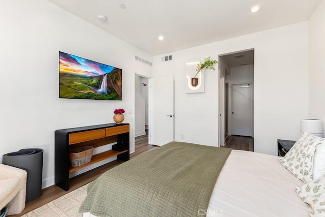 bedroom featuring recessed lighting, visible vents, wood finished floors, and a spacious closet