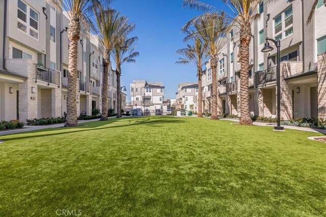 view of community featuring a residential view and a yard