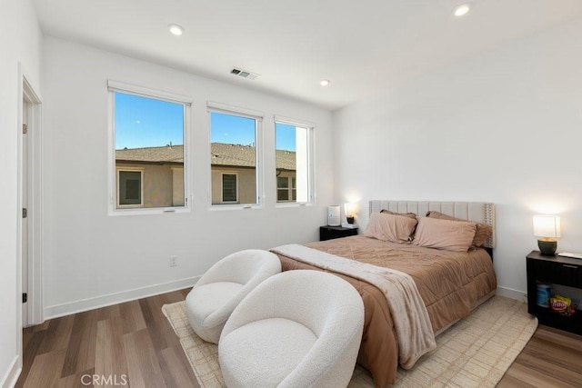 bedroom with visible vents, recessed lighting, baseboards, and wood finished floors