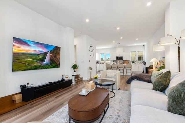 living room with recessed lighting and light wood finished floors