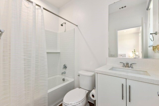 full bathroom with visible vents, shower / tub combo with curtain, vanity, and toilet