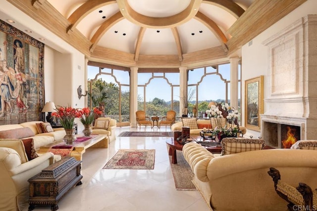 living area with a high end fireplace and high vaulted ceiling