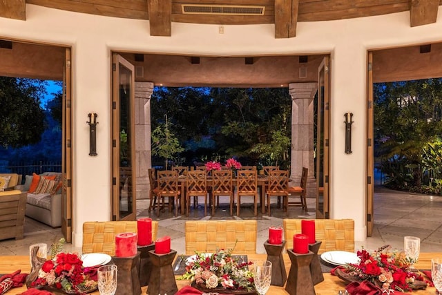 dining area featuring beam ceiling, visible vents, and tile patterned flooring