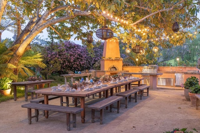 view of patio / terrace featuring area for grilling, outdoor dining space, and a fireplace