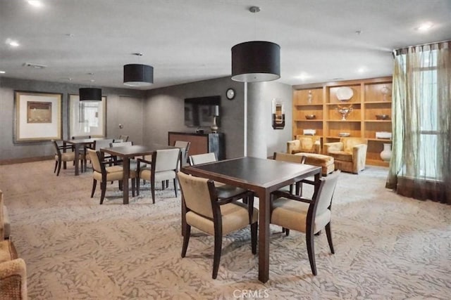 dining area with recessed lighting and light carpet