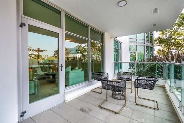 balcony with visible vents and a sunroom