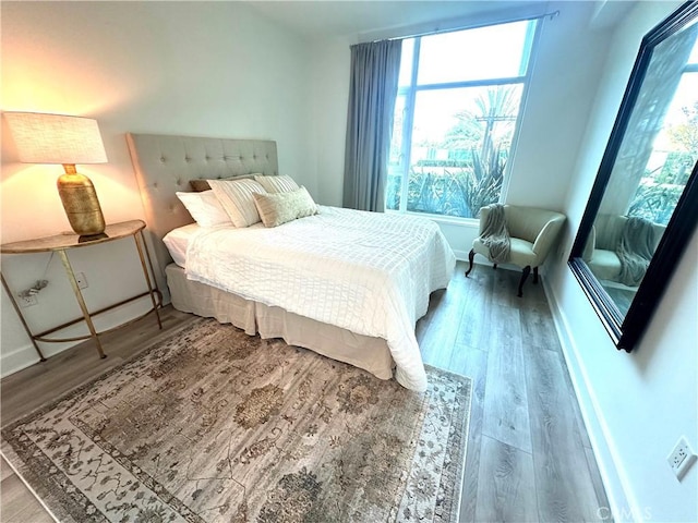 bedroom featuring wood finished floors and baseboards