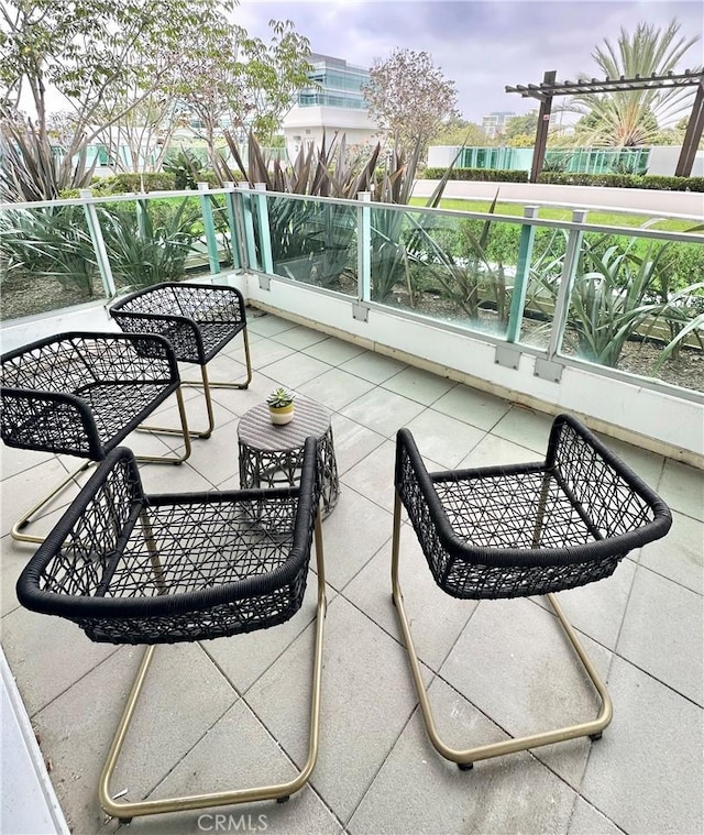 view of patio featuring a balcony