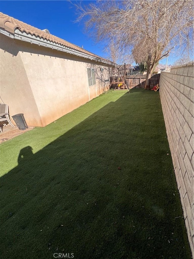 view of yard with a fenced backyard