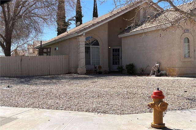 view of property exterior featuring fence and stucco siding