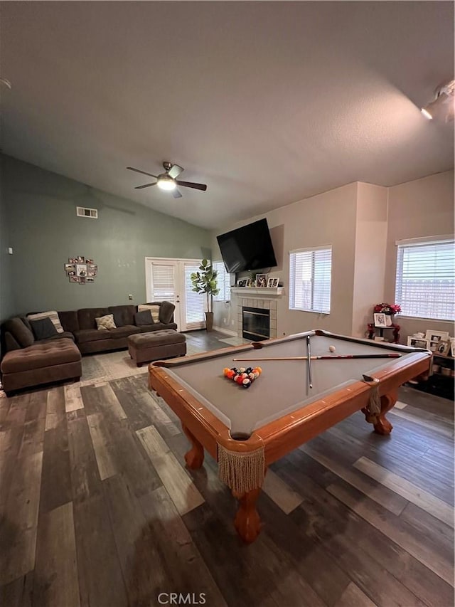 rec room with visible vents, a tiled fireplace, dark wood-style floors, pool table, and lofted ceiling