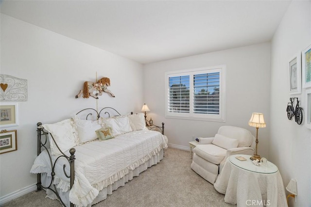 carpeted bedroom featuring baseboards