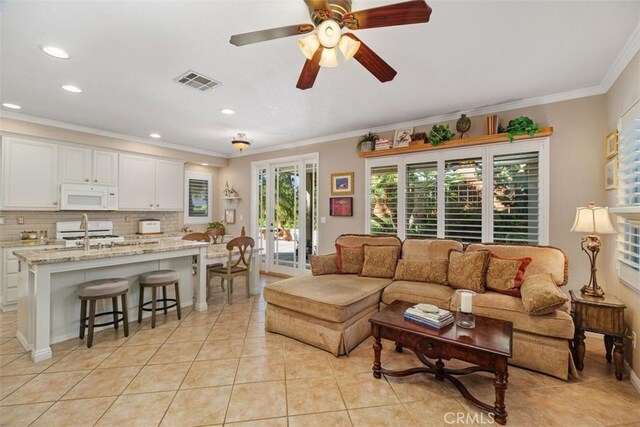 living area with visible vents, recessed lighting, crown molding, light tile patterned floors, and ceiling fan