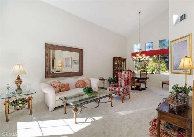 carpeted living room with a notable chandelier, baseboards, visible vents, and high vaulted ceiling