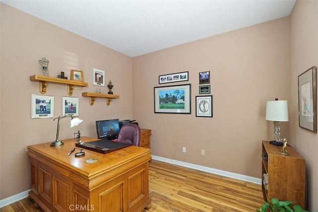 home office featuring light wood-type flooring and baseboards