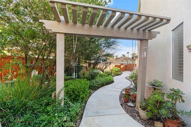 view of community featuring a pergola and a fenced backyard