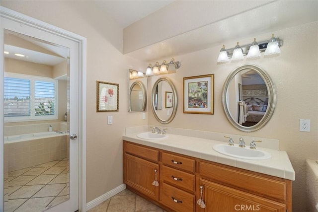 full bath with double vanity, a garden tub, tile patterned floors, and a sink