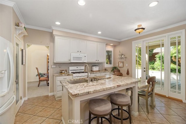 kitchen featuring decorative backsplash, ornamental molding, white appliances, and a sink