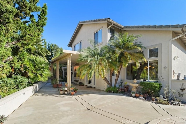 exterior space featuring a patio and stucco siding