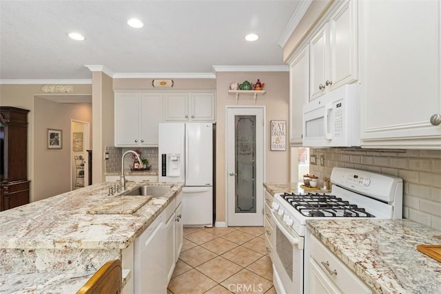 kitchen featuring a sink, white appliances, white cabinets, and crown molding