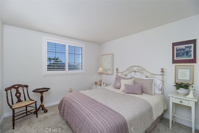 carpeted bedroom featuring baseboards