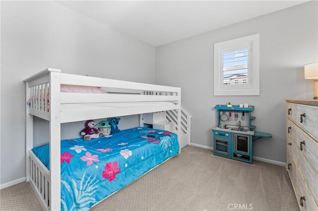 bedroom featuring carpet and baseboards