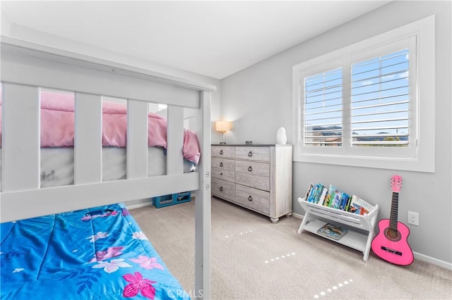 bedroom with baseboards and carpet