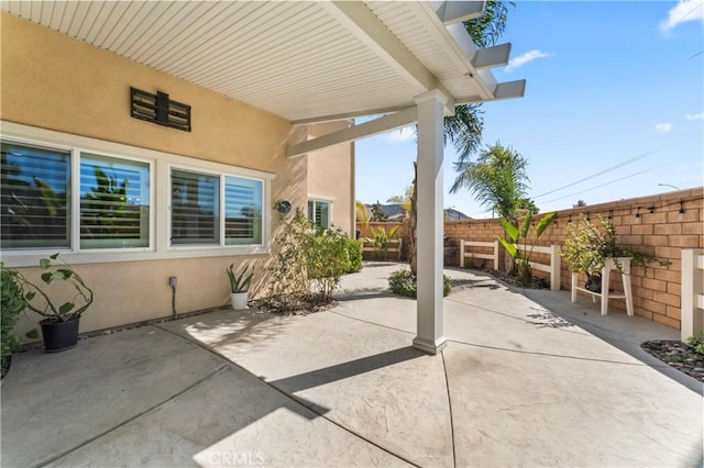 view of patio featuring fence